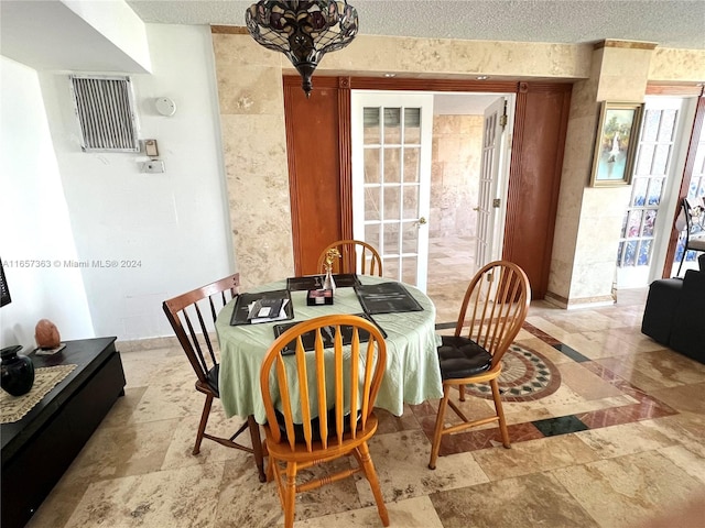 dining space featuring a textured ceiling
