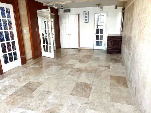 spare room featuring french doors