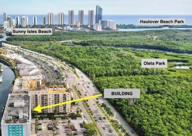 birds eye view of property with a water view and a view of city