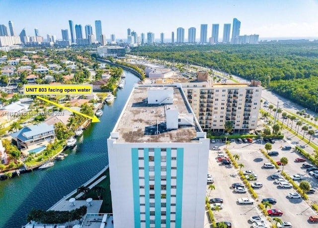 birds eye view of property featuring a water view and a view of city