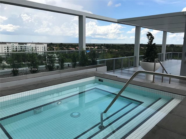 view of pool featuring an in ground hot tub