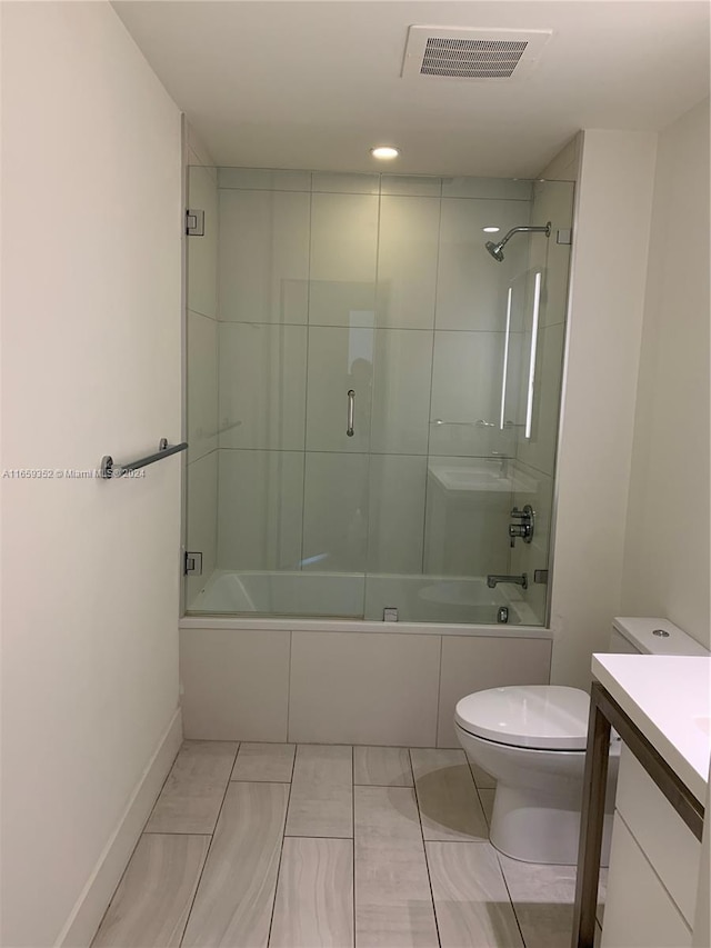 full bathroom with shower / bath combination with glass door, vanity, and toilet