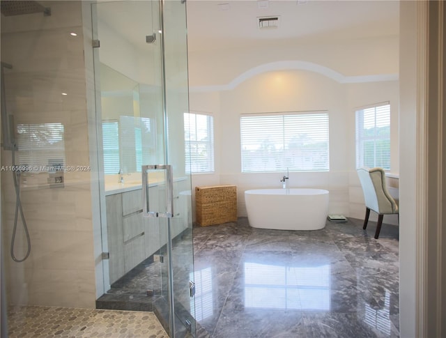 bathroom with tile walls, vanity, and plus walk in shower