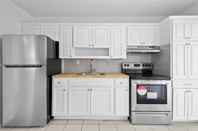 kitchen with decorative backsplash, white cabinetry, sink, and appliances with stainless steel finishes