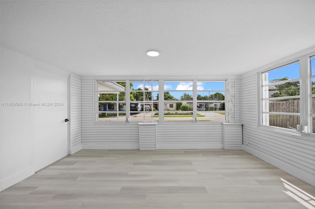 unfurnished sunroom with a wealth of natural light