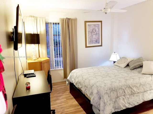 bedroom with ceiling fan and light hardwood / wood-style floors