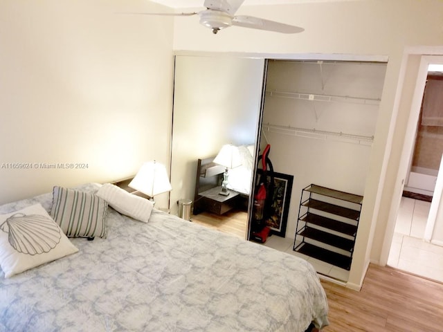 bedroom featuring ceiling fan, hardwood / wood-style floors, and a closet