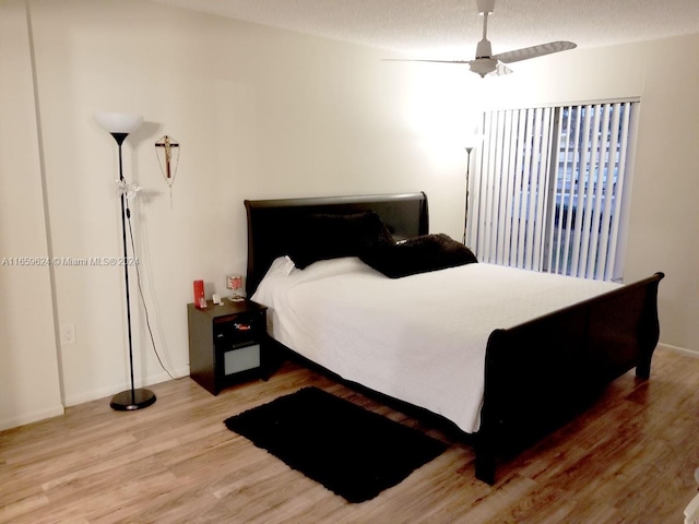 bedroom featuring ceiling fan and wood-type flooring