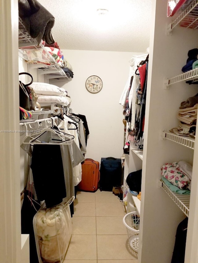 spacious closet with light tile patterned floors