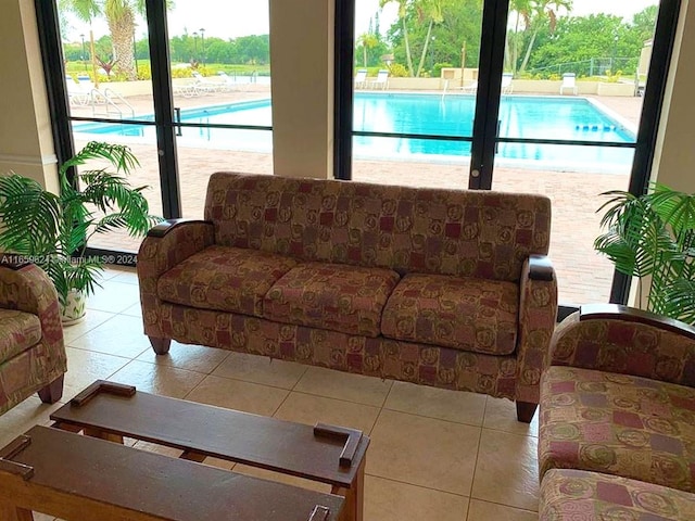 living room with a wealth of natural light and tile patterned flooring