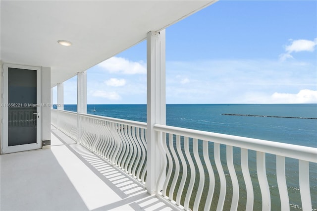 balcony with a water view and a beach view