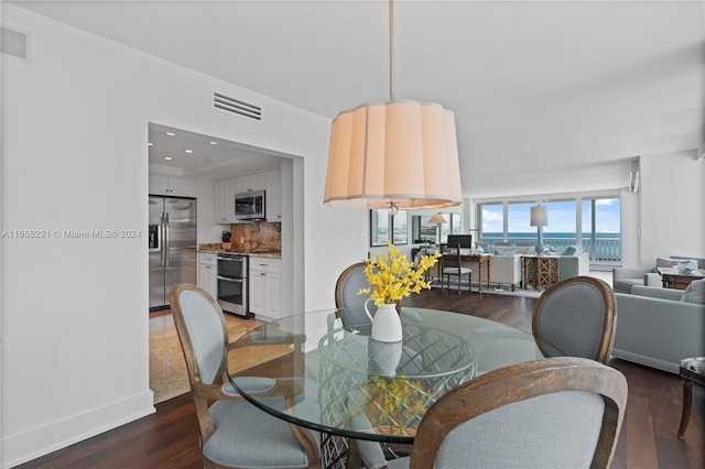 dining space with dark wood-type flooring