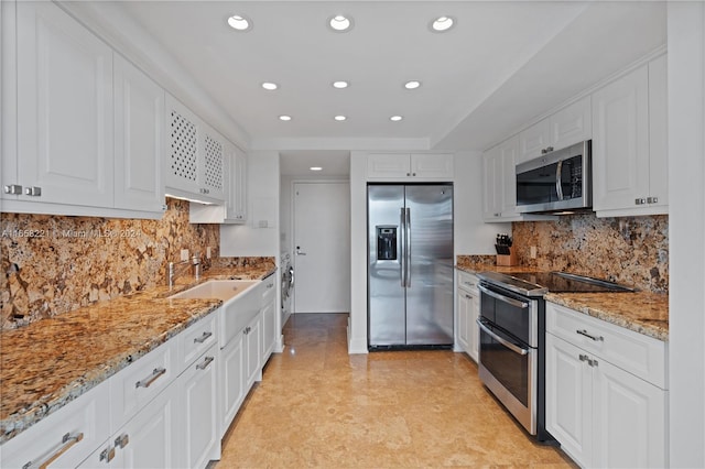 2200 S Ocean Ln Unit 702, Fort Lauderdale, FL 33316 - kitchen featuring light stone counters, recessed lighting, a sink, stainless steel appliances, and white cabinets