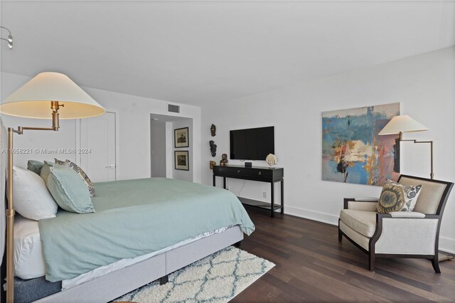 bedroom with dark hardwood / wood-style flooring