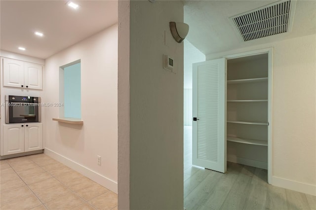 corridor featuring light hardwood / wood-style floors