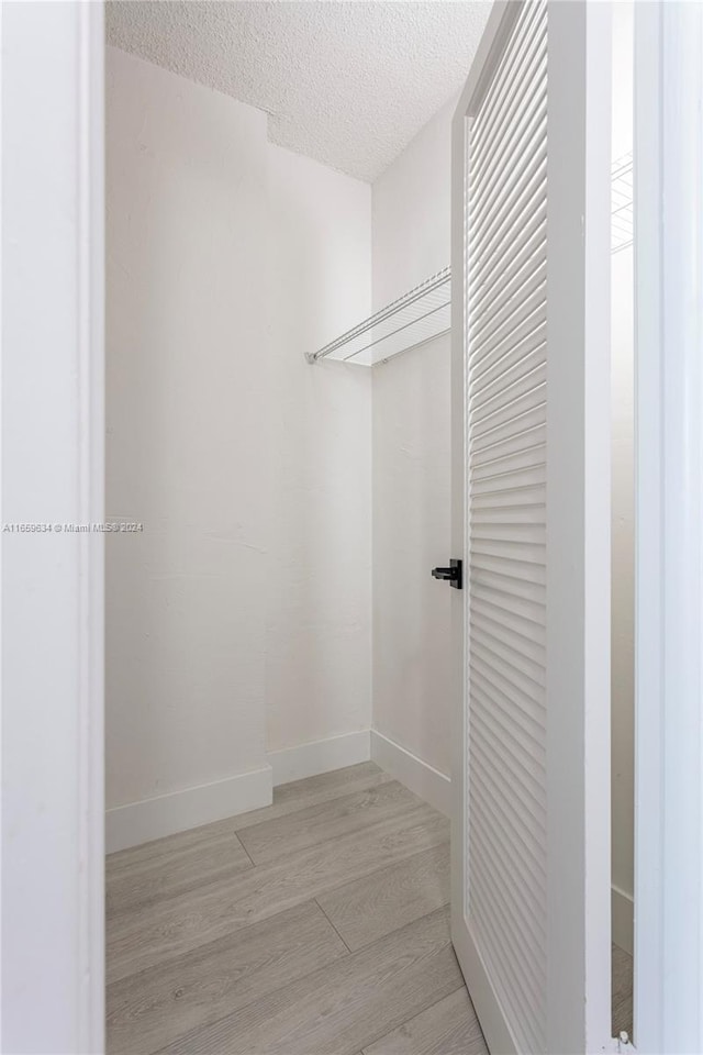 interior space featuring a textured ceiling and light hardwood / wood-style flooring