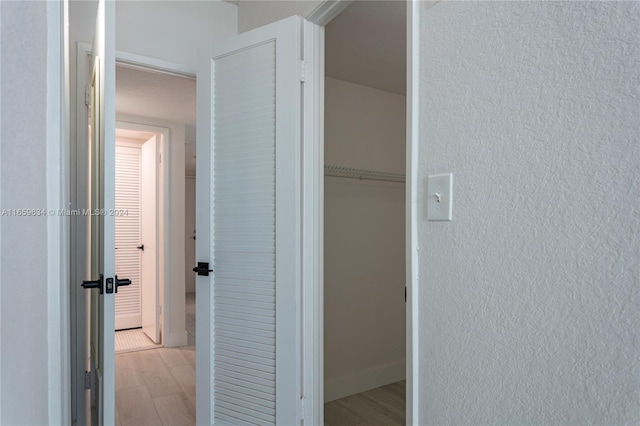 hallway with light hardwood / wood-style flooring