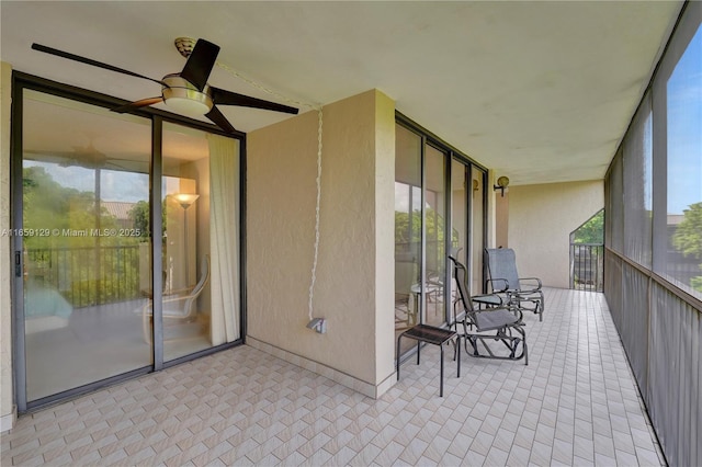 unfurnished sunroom with plenty of natural light and ceiling fan