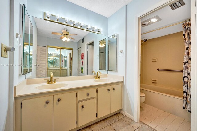 full bathroom featuring toilet, vanity, shower / bathtub combination with curtain, ceiling fan, and tile patterned flooring