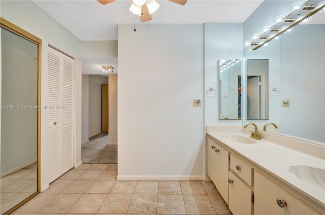 bathroom with vanity, ceiling fan, tile patterned floors, and a textured ceiling