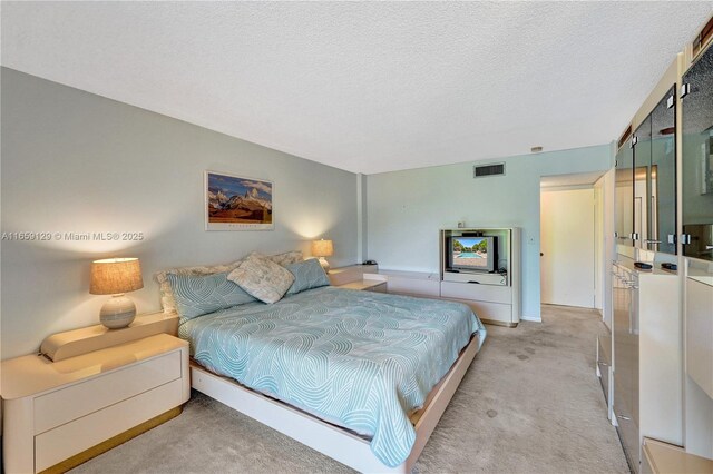 carpeted bedroom with a textured ceiling