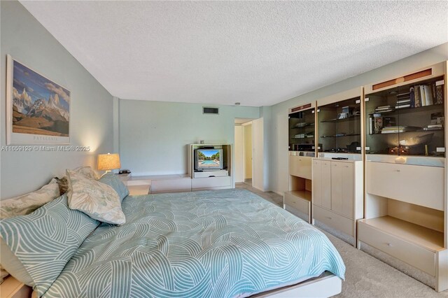 carpeted bedroom with a textured ceiling