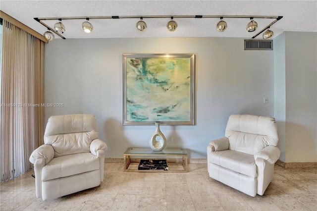 living area with a textured ceiling