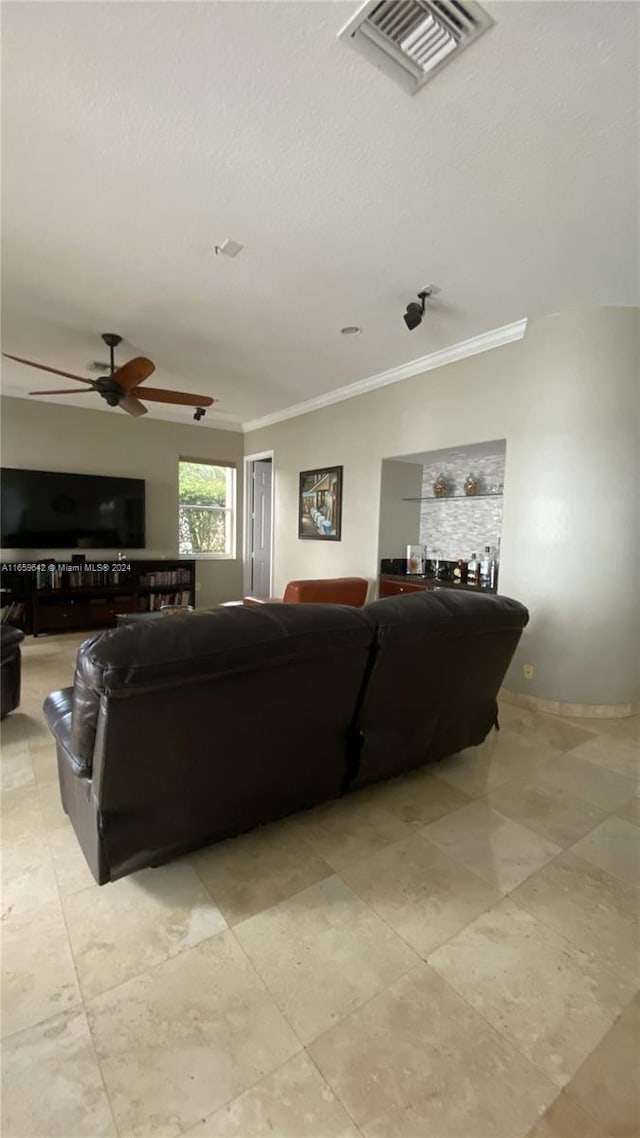 living room with crown molding and ceiling fan