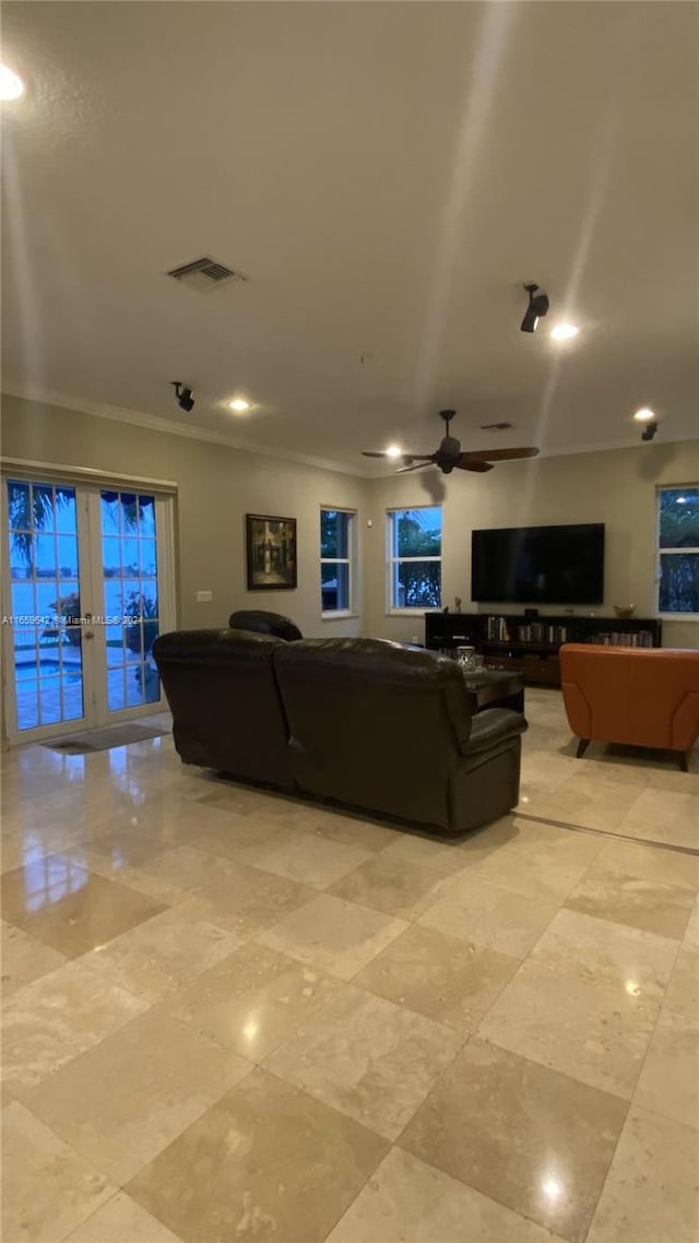 living room with ornamental molding, french doors, and ceiling fan