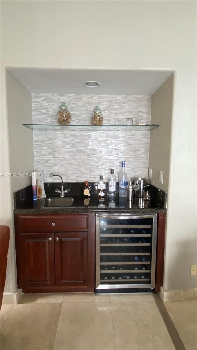 bar featuring beverage cooler, light tile patterned floors, and sink