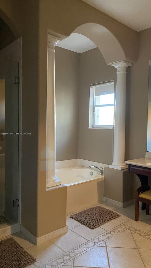 bathroom with ornate columns, separate shower and tub, and tile patterned flooring