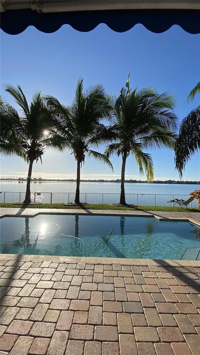 view of swimming pool with a water view