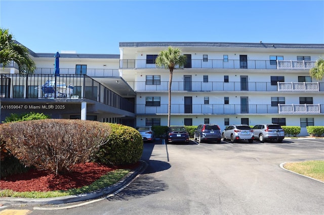 view of building exterior with uncovered parking