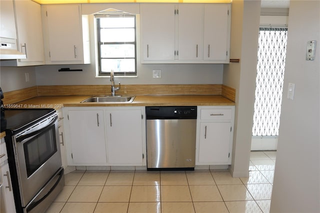 kitchen with a healthy amount of sunlight, stainless steel appliances, sink, and white cabinetry