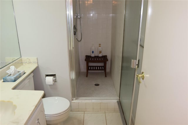 bathroom featuring an enclosed shower, tile patterned flooring, toilet, and vanity