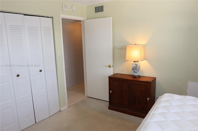 carpeted bedroom featuring a closet