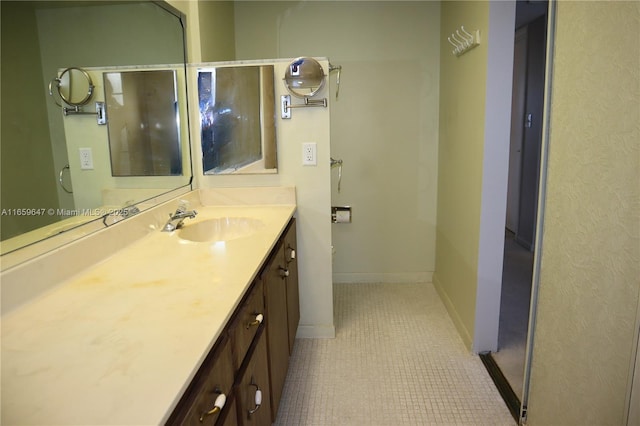 bathroom featuring tile patterned floors, baseboards, and vanity