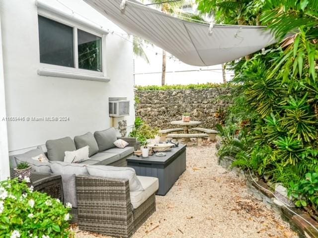 view of patio featuring outdoor lounge area and a wall mounted air conditioner