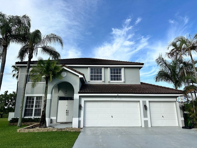 view of front of home with a garage and a front yard