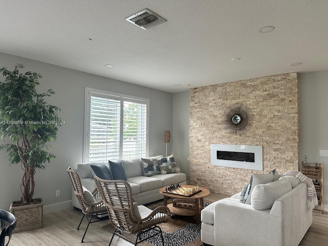 living room with hardwood / wood-style floors and a textured ceiling