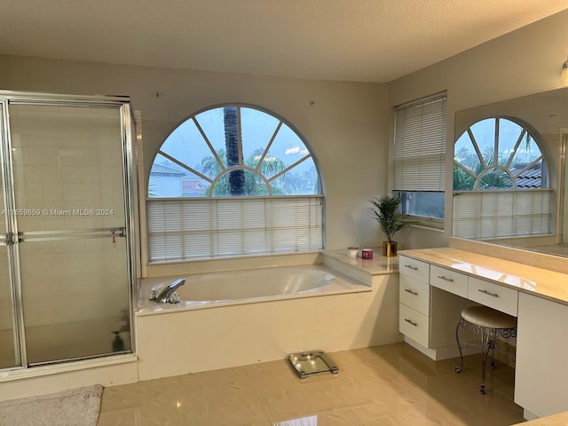 bathroom featuring tile patterned flooring, a textured ceiling, vanity, and independent shower and bath