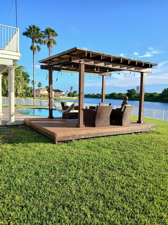 dock area featuring a yard, a water view, and a balcony