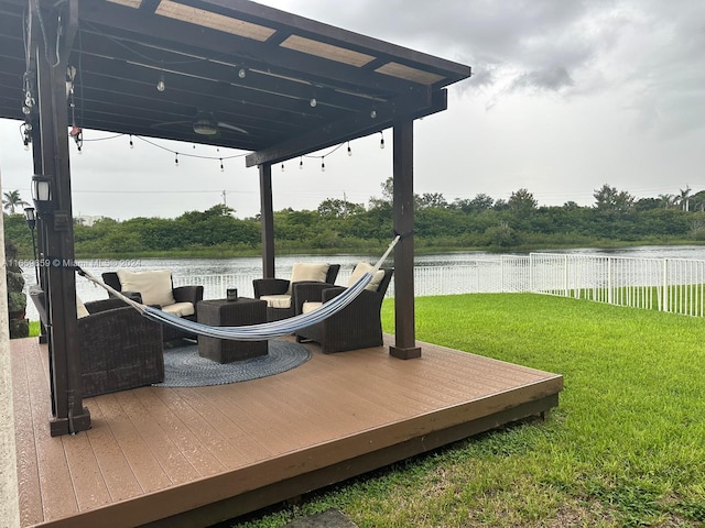 wooden deck with a lawn and a water view