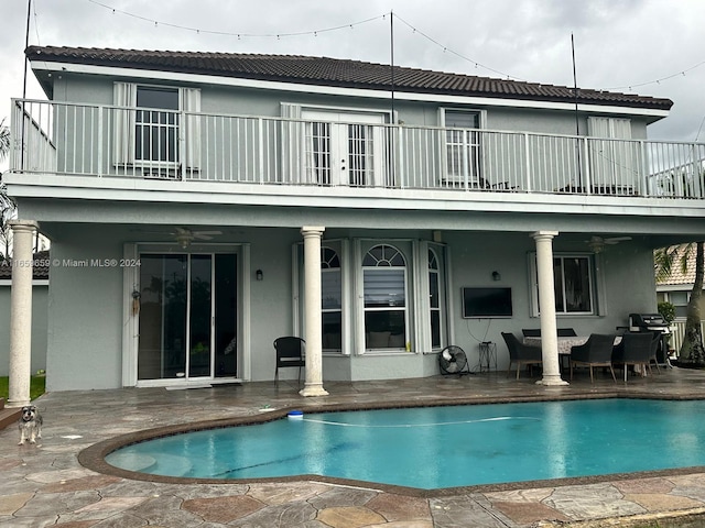 back of property with a patio area, ceiling fan, and an outdoor living space