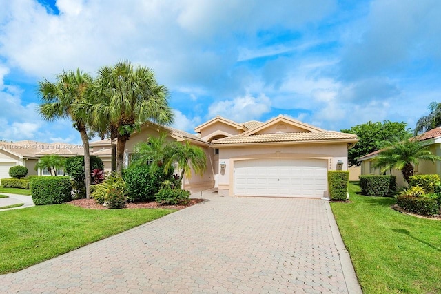 mediterranean / spanish-style house featuring a front lawn and a garage