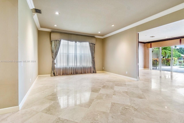 spare room with ornamental molding and a textured ceiling