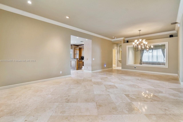 spare room with ornamental molding and a notable chandelier