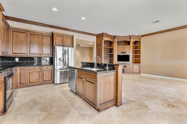 kitchen with dark stone counters, crown molding, sink, appliances with stainless steel finishes, and a center island with sink