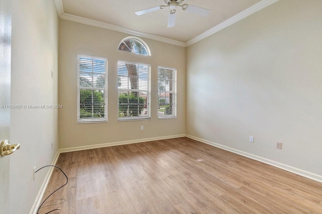 empty room featuring ceiling fan, ornamental molding, and light wood-type flooring