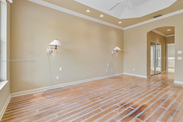 empty room with ceiling fan, crown molding, and light hardwood / wood-style flooring